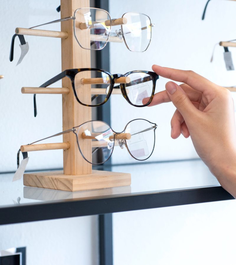 Hand,Of,Woman,Choosing,The,Glasses,In,Optics,Store,,Eyesight